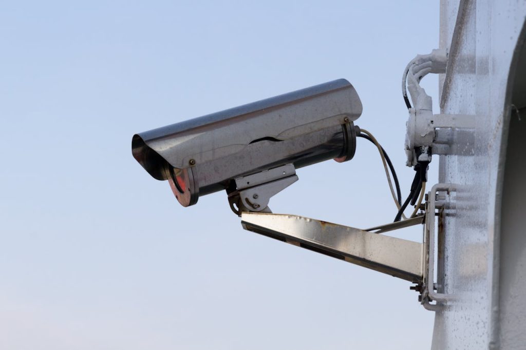 pexels photo 207574 Close-up of an outdoor CCTV camera installed on a wall for security purposes.