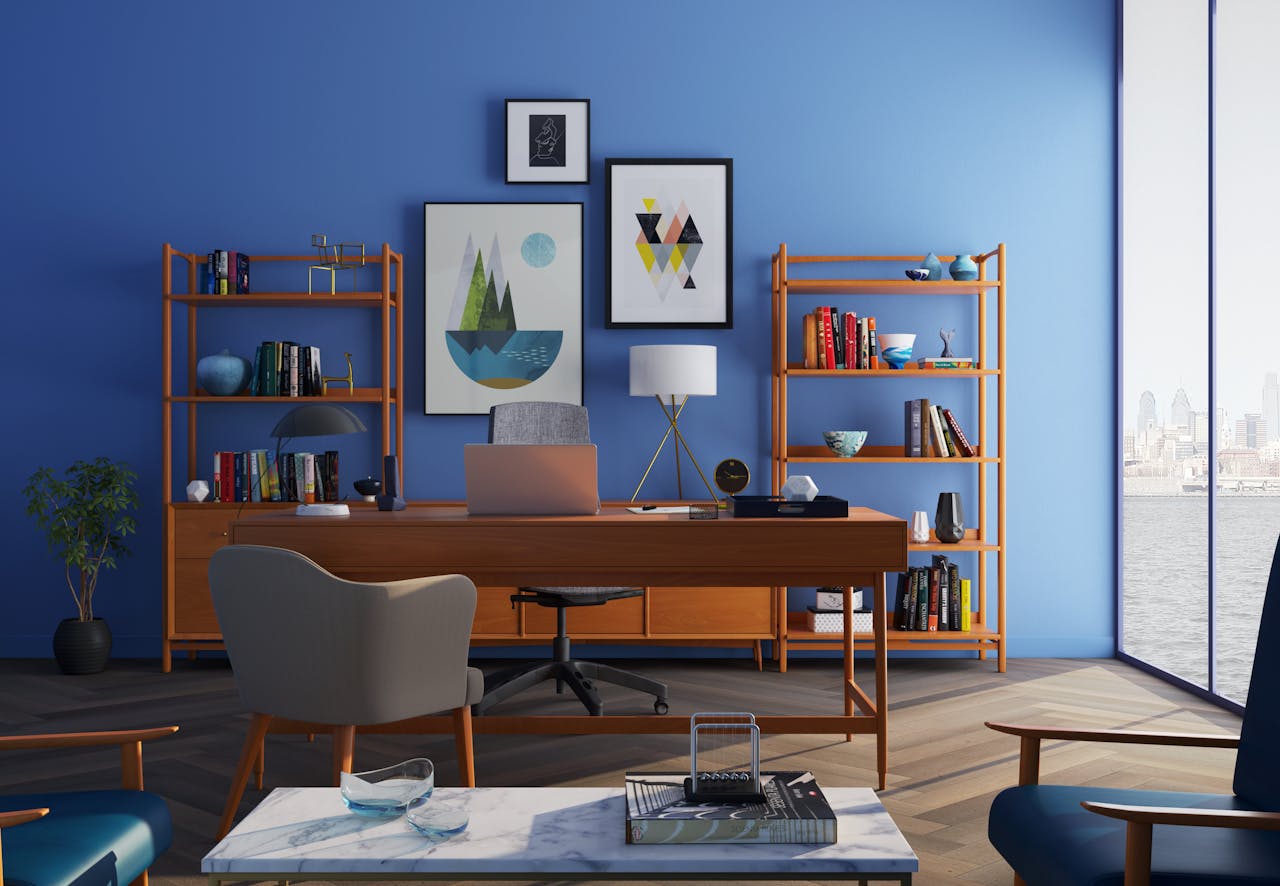 who-we-are Elegantly decorated home office with modern furniture and a blue wall.